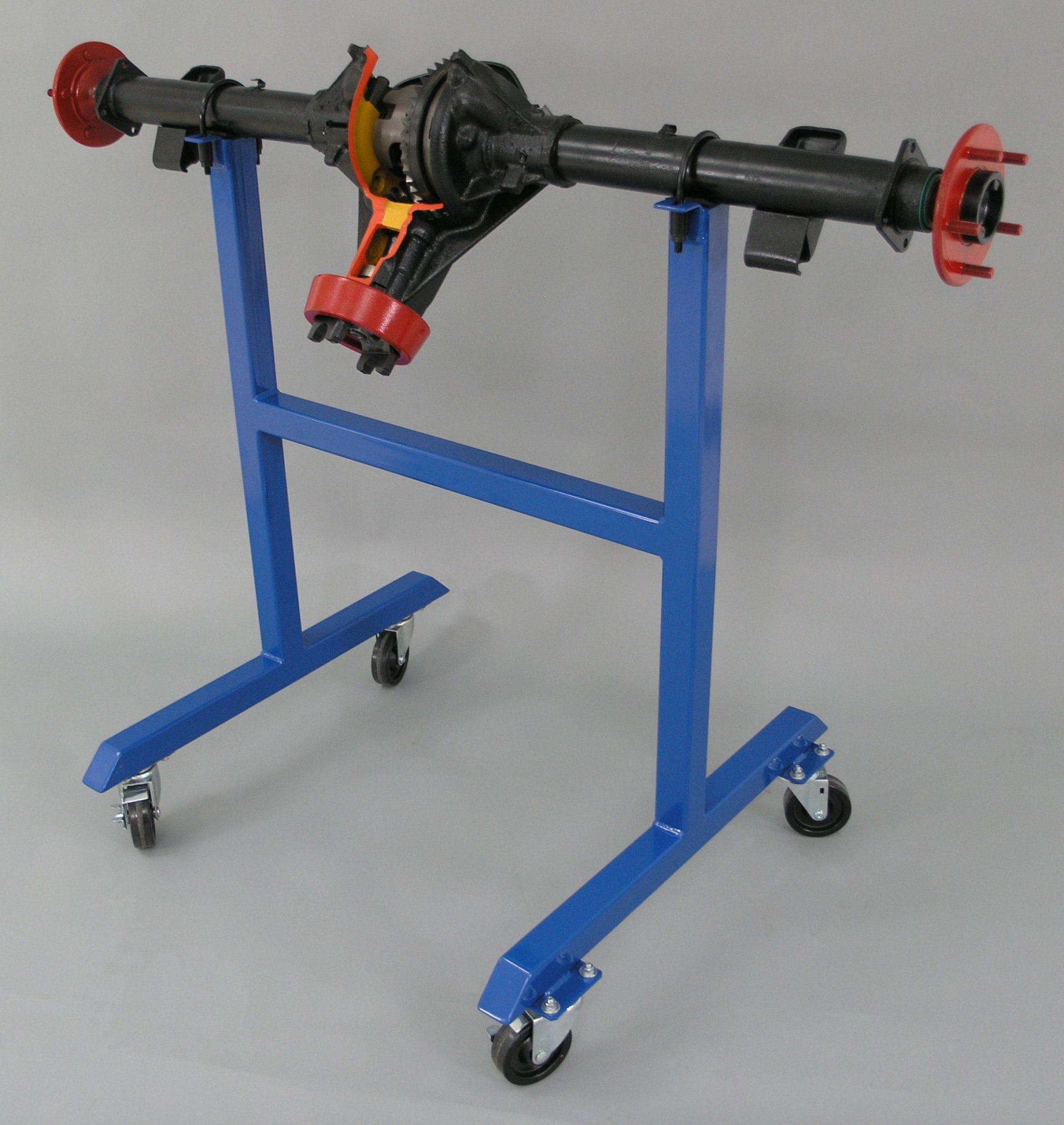 A blue stand with wheels has a black axle on it