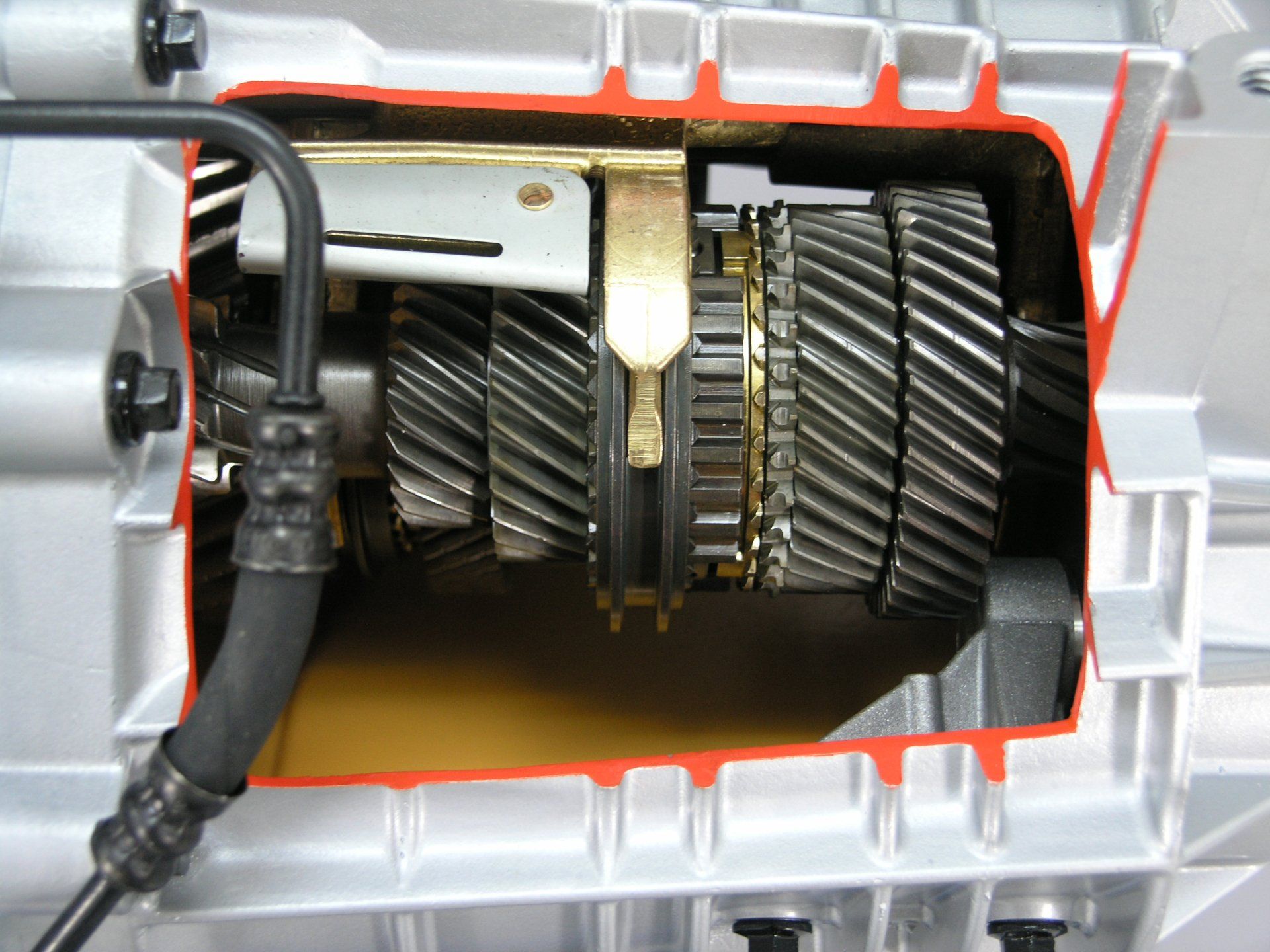 A close up of a gearbox with a hose attached to it