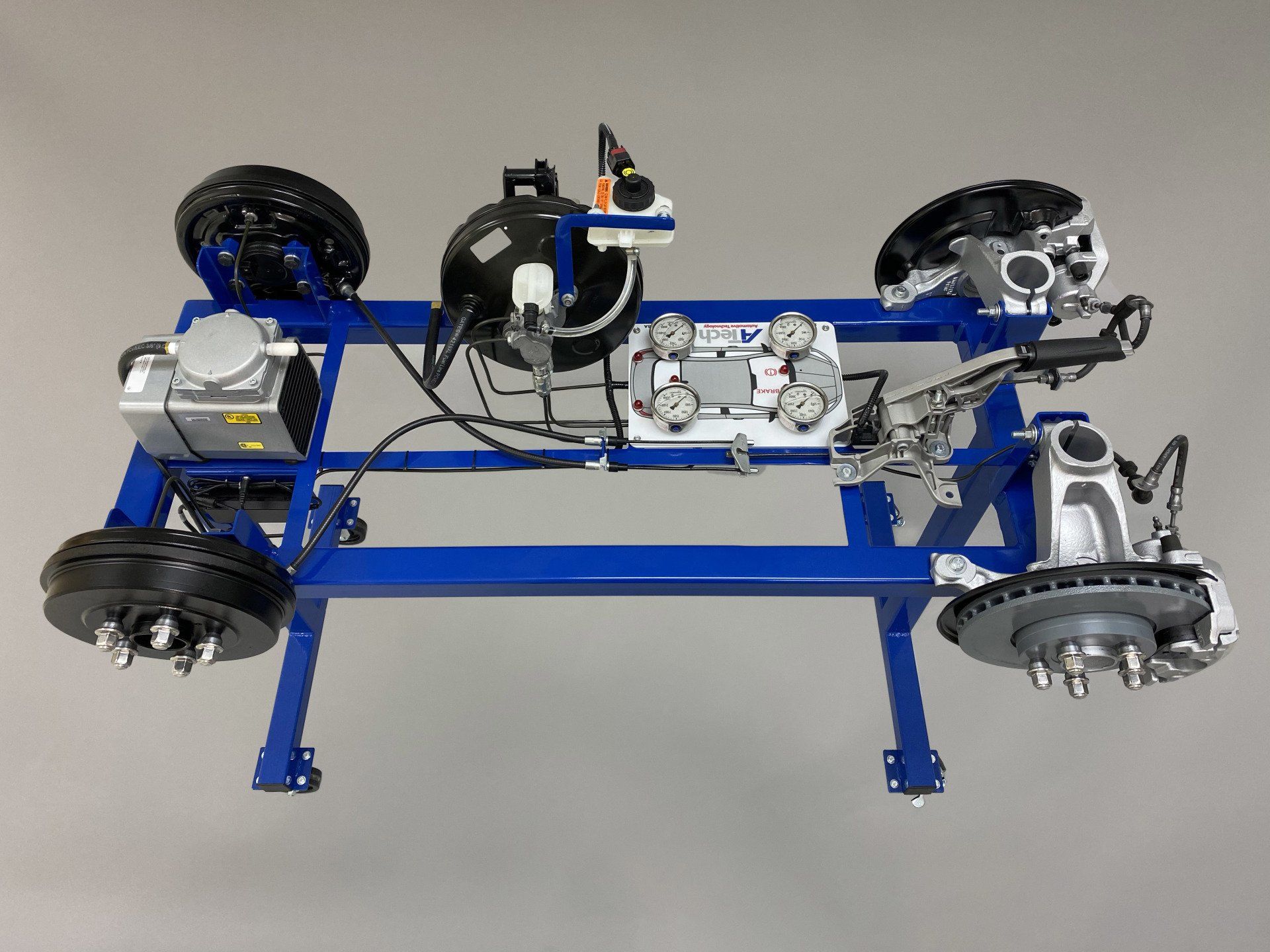 A model of a car 's brake system is sitting on a blue stand.