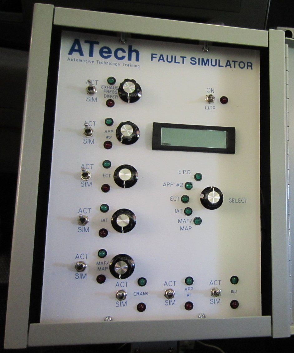 A white atech fault simulator with buttons and a monitor