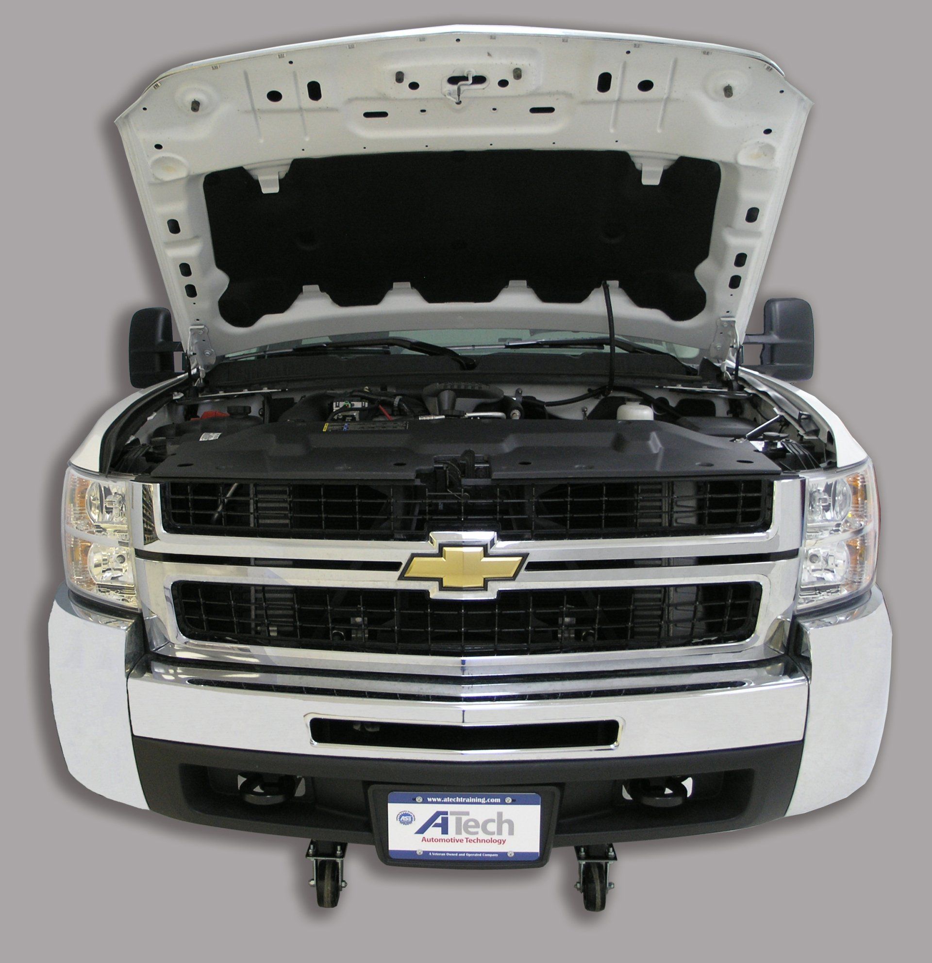 A white chevrolet truck with the hood open