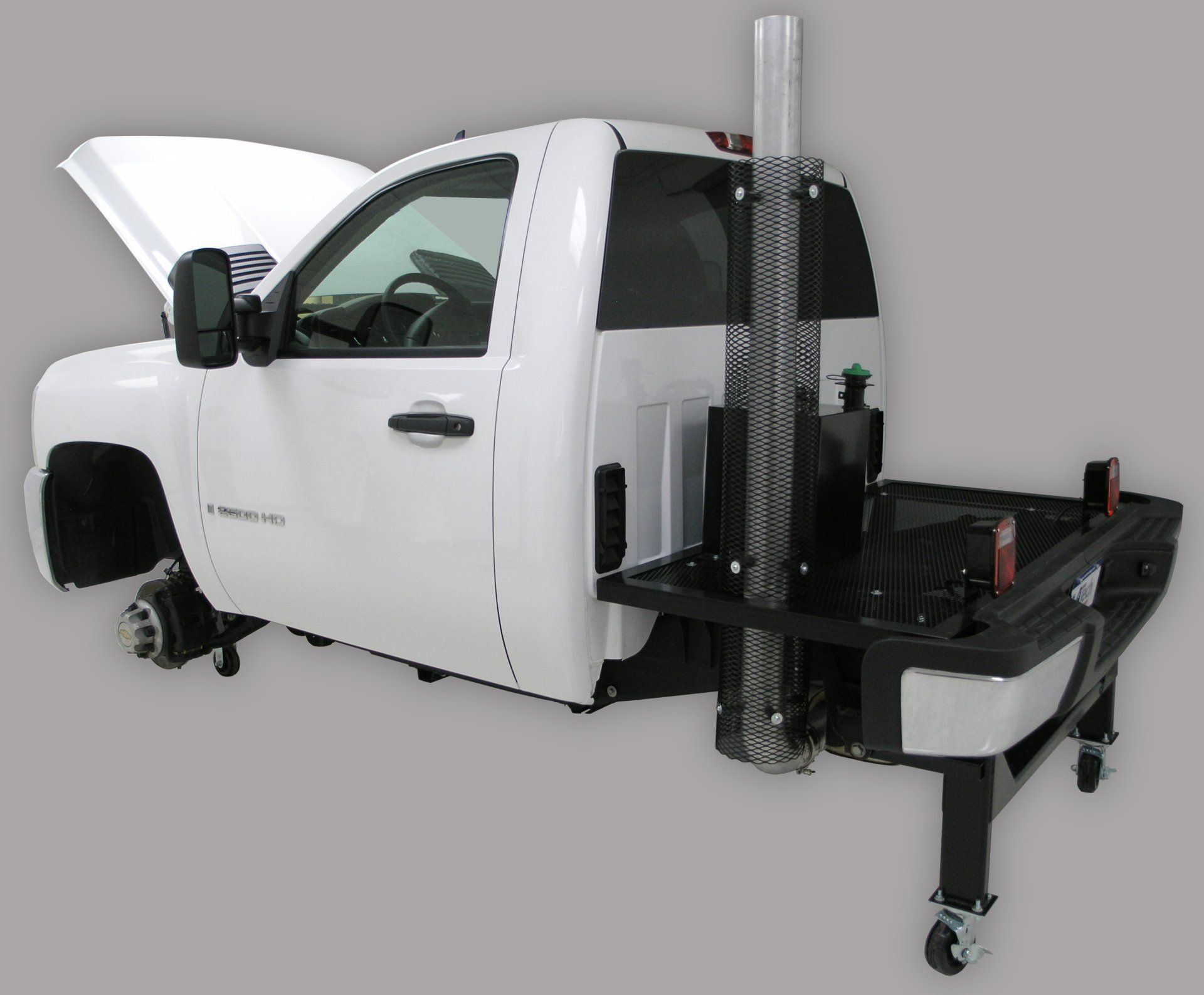 A white truck with the hood open is sitting on a table