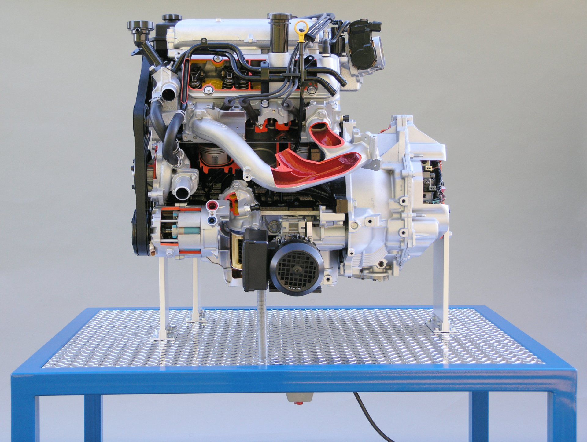 A model of a car engine is sitting on a blue table