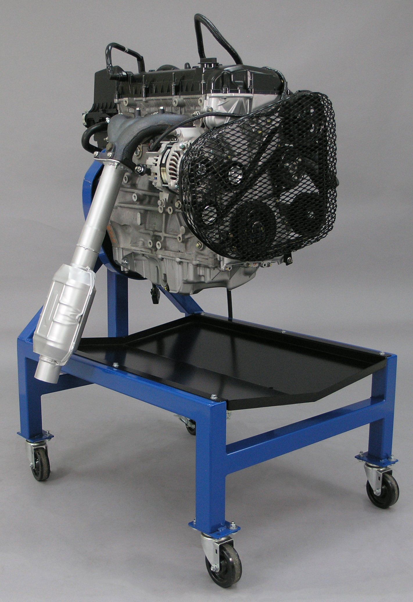 A motor is sitting on a blue cart with wheels