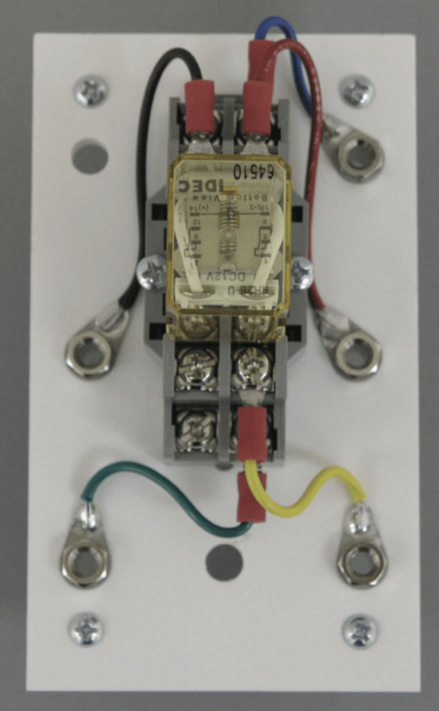 A close up of a relay with wires attached to it