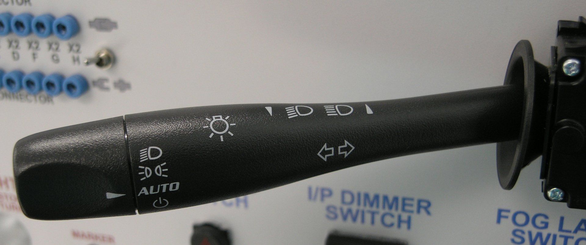 A close up of a black up dimmer switch