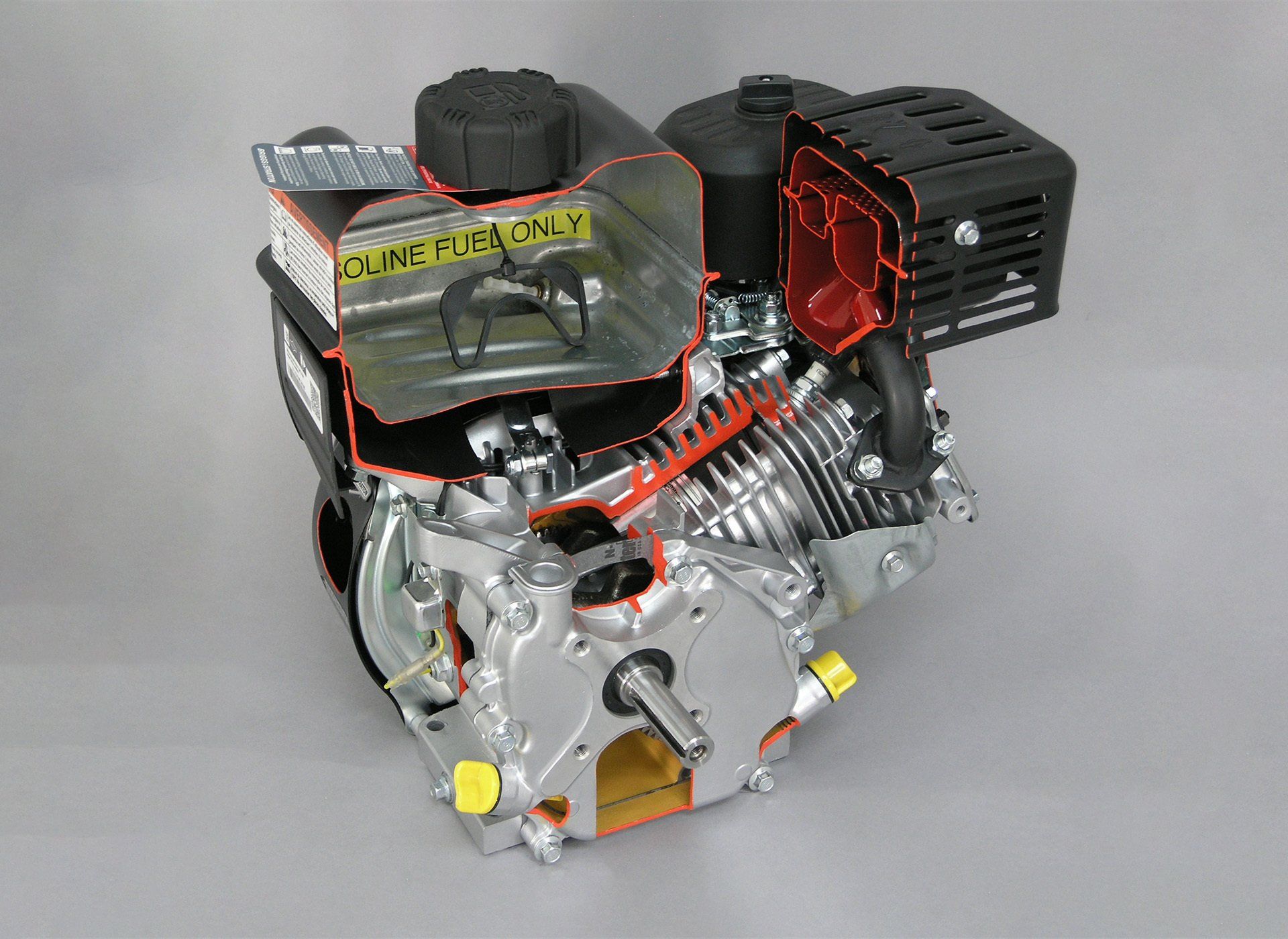 A close up of a cut in half engine on a table.