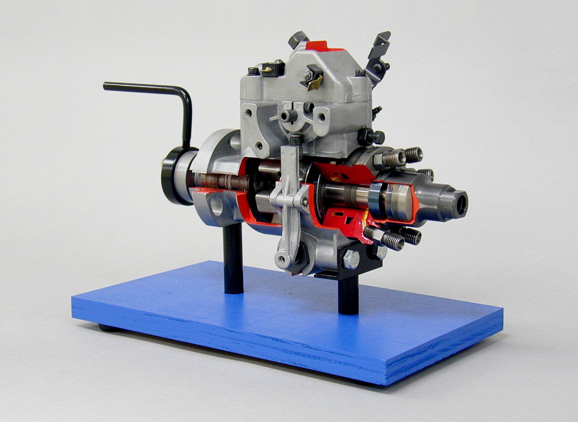 A model of a fuel pump on a blue base
