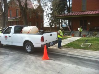 Lawn Mowing — Parked White Truck and Employees Working on a Lawn in El Paso, TX