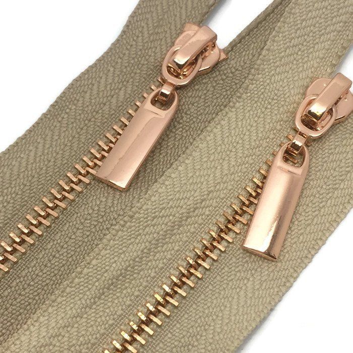 Beige zipper with copper chain and pull tab