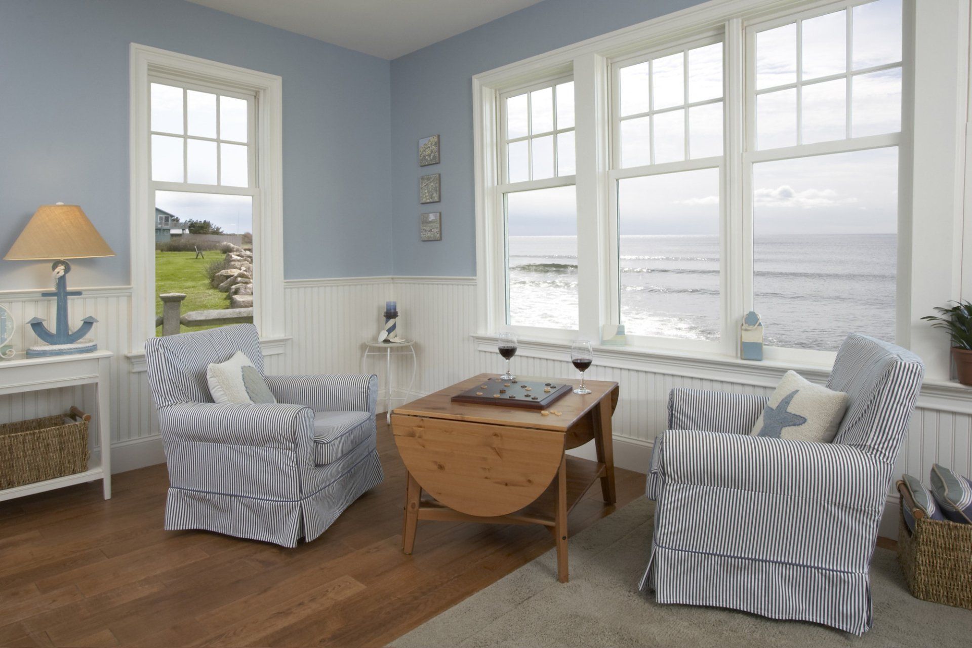 Luxury living room interior with windows and seascape view