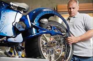 Mechanic repairing tire at work - Custom Motorcycle Repair in Weare, NH