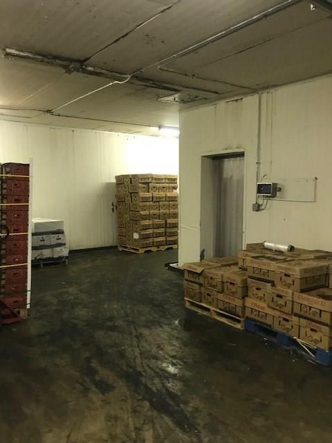 A warehouse filled with lots of boxes and pallets.