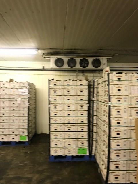 A warehouse filled with lots of boxes stacked on top of each other