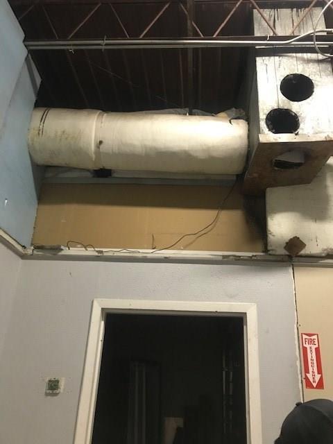A room with a fire exit sign on the wall