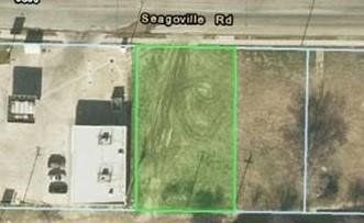 An aerial view of a lot with a green border.
