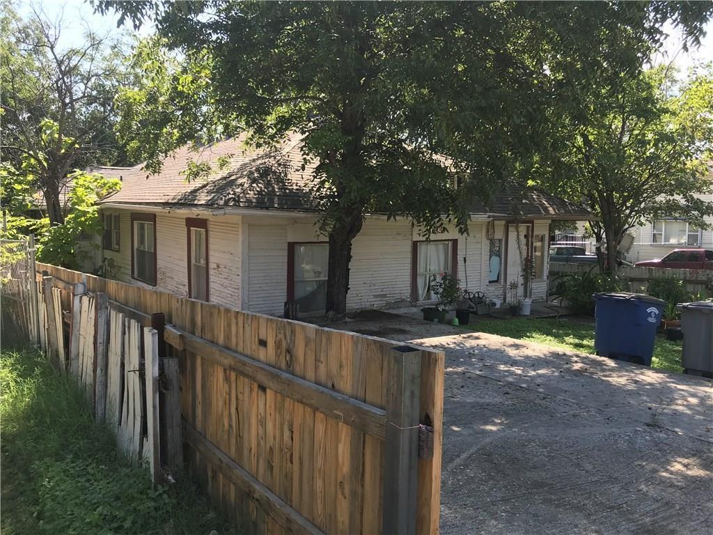 A house with a wooden fence surrounding it