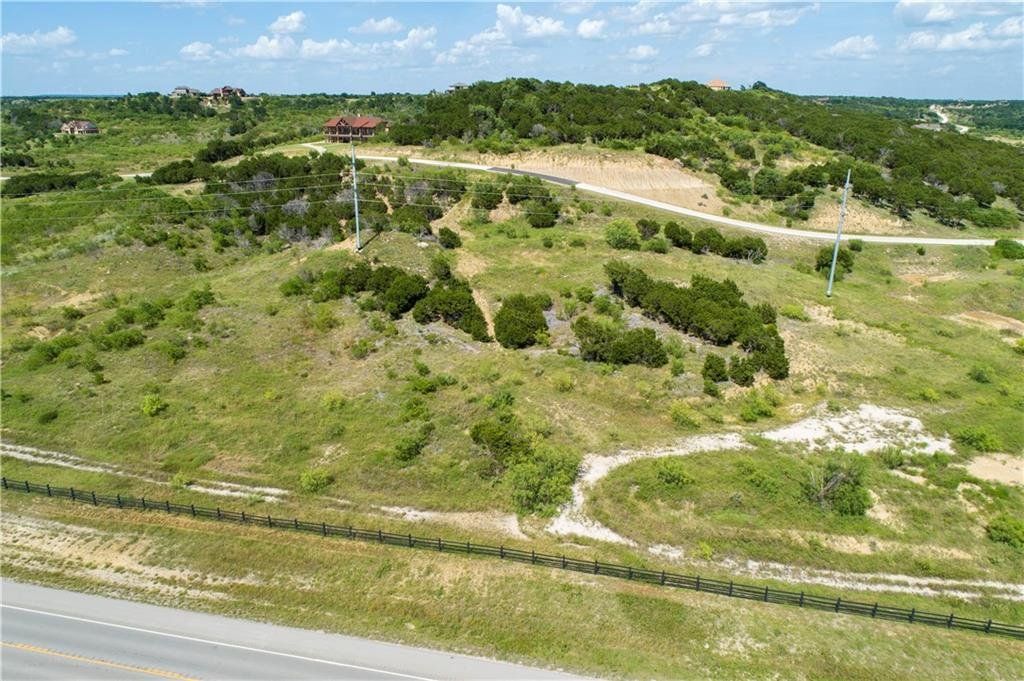 An aerial view of a grassy hillside next to a road.