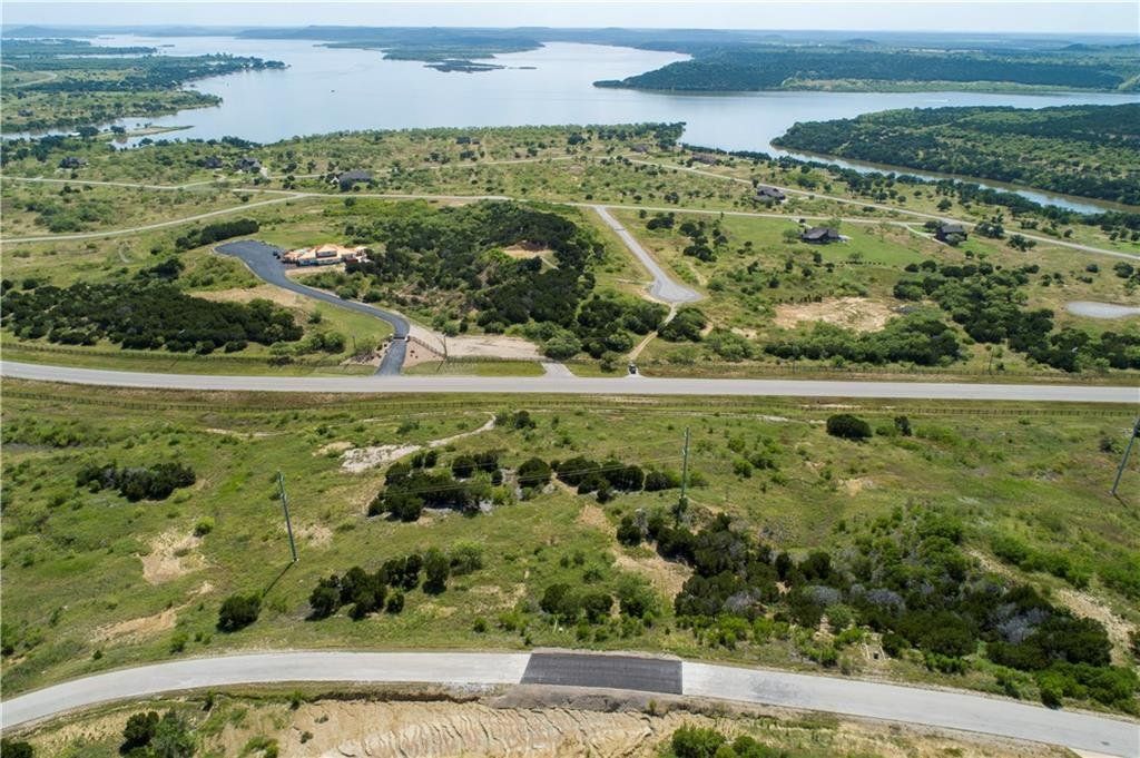 An aerial view of a residential area with a lake in the background.