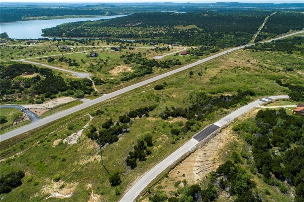 An aerial view of a residential area with a lake in the background.