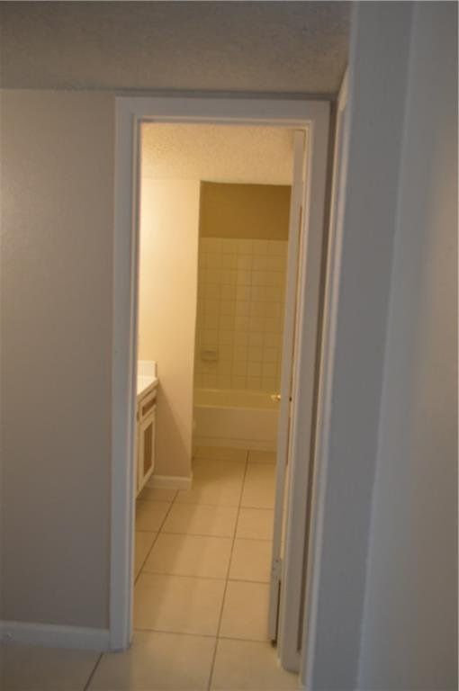 A doorway leading to a bathroom with a bathtub