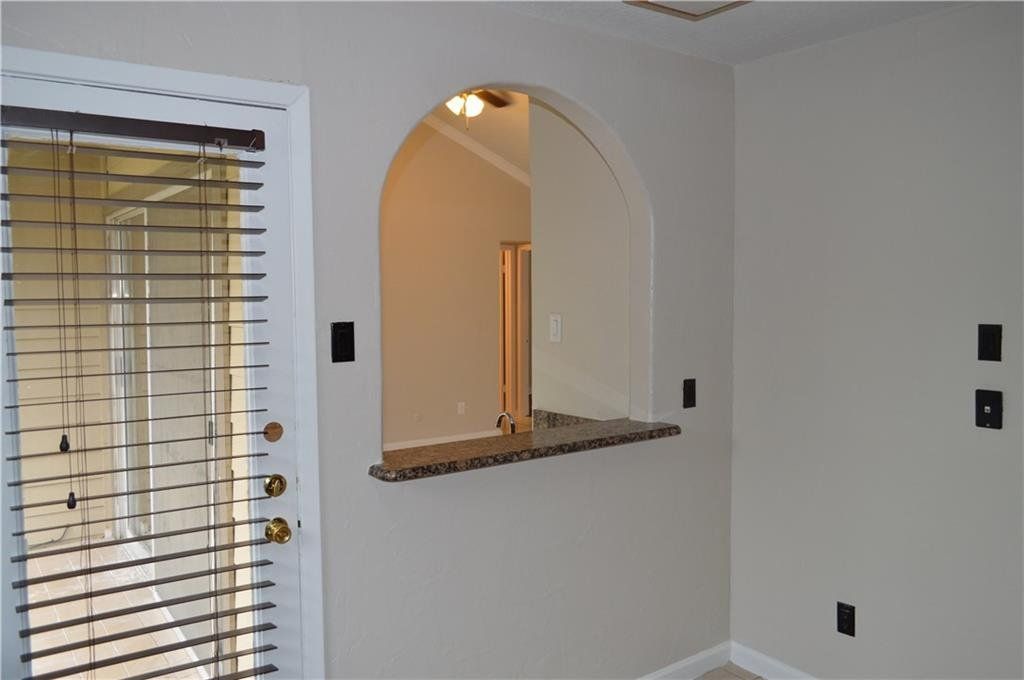 An empty room with a window and blinds