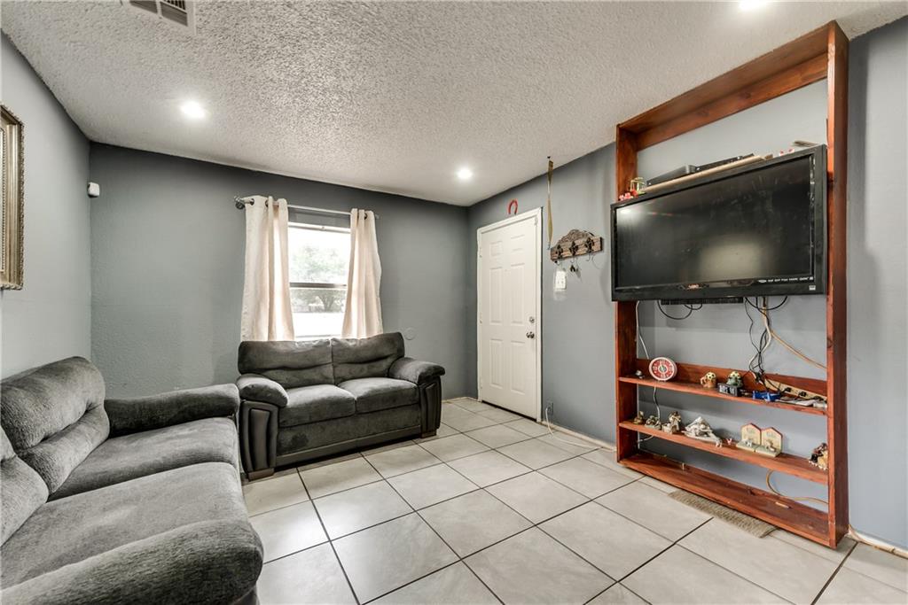 A living room with a couch and a flat screen tv