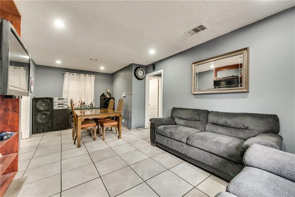 A living room with a couch a table and chairs