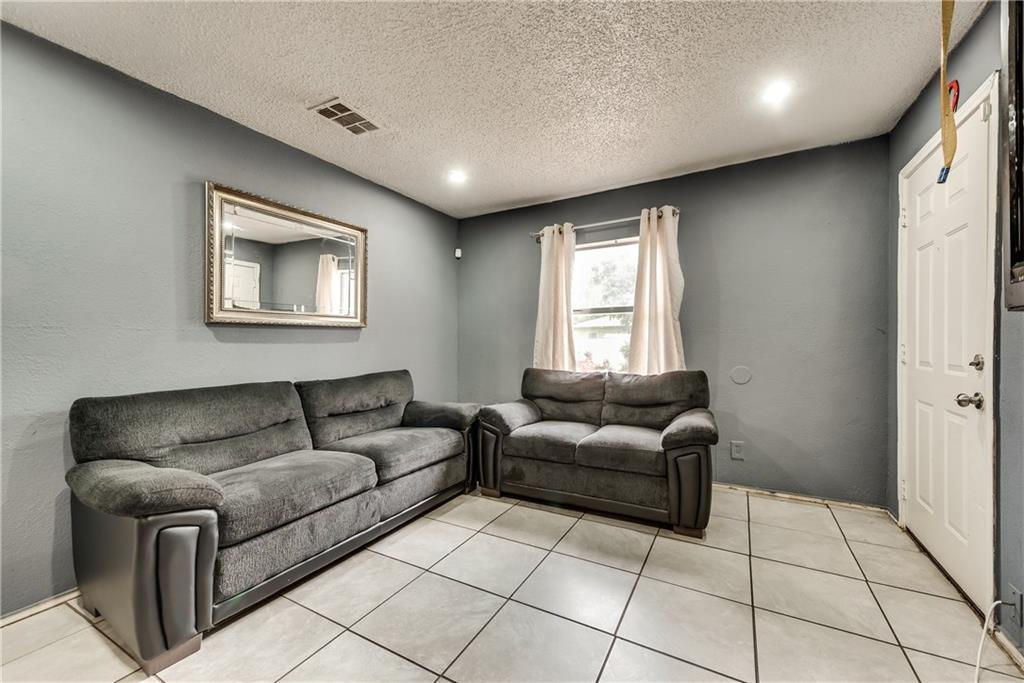 A living room with two couches and a mirror on the wall.