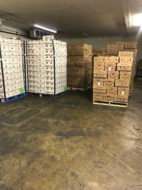 A warehouse filled with lots of boxes and pallets.