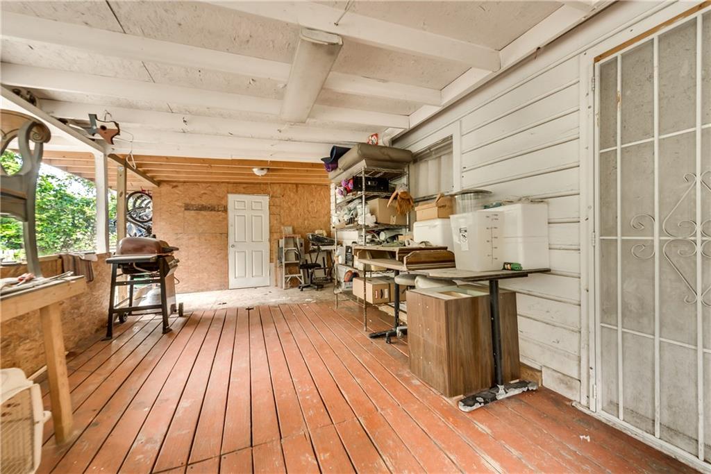 A large room with a wooden floor and a white wall.