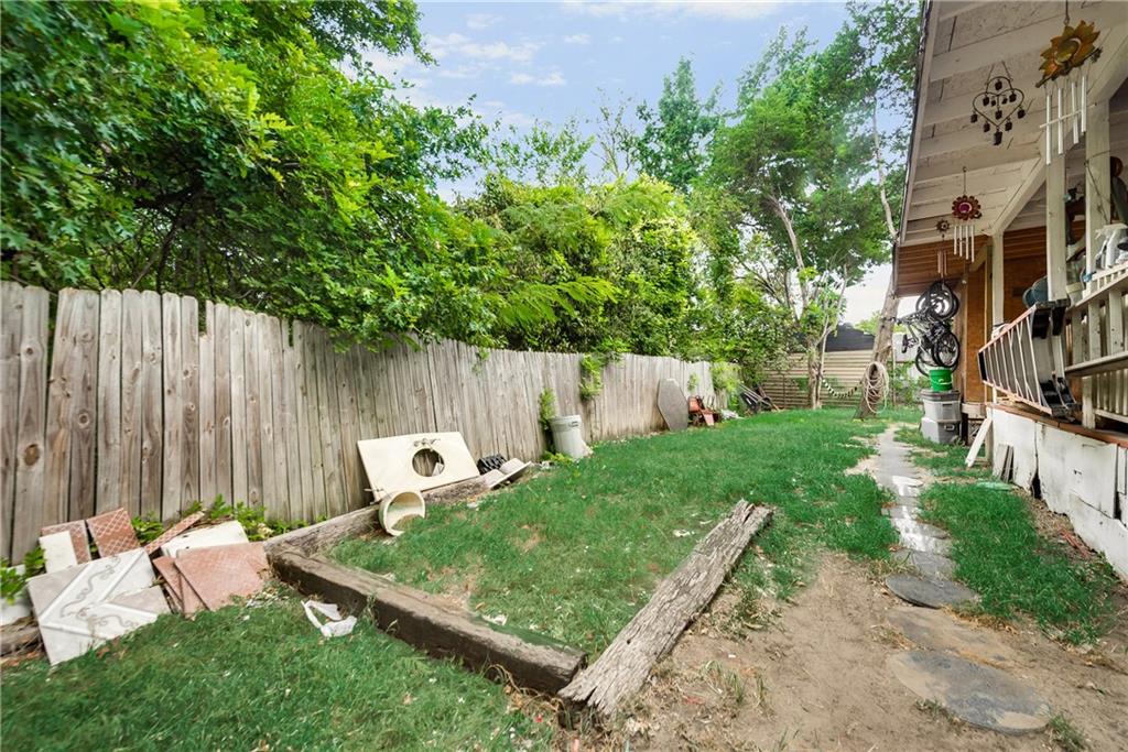 There is a wooden fence in the backyard of a house.