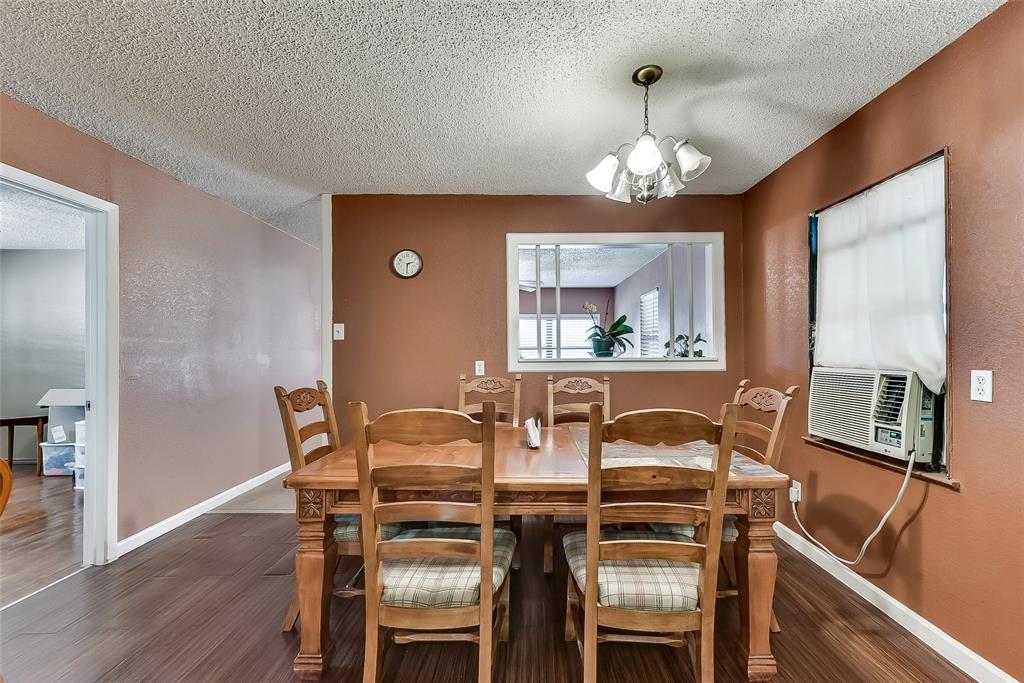 A dining room with a wooden table and chairs
