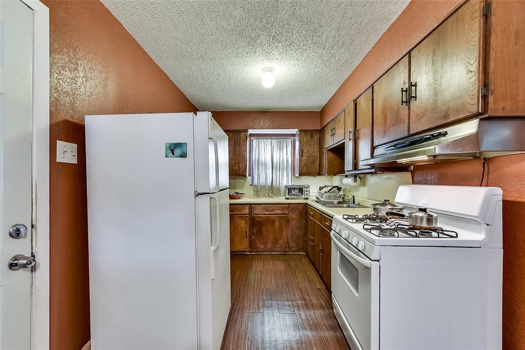 A kitchen with a stove , refrigerator and freezer