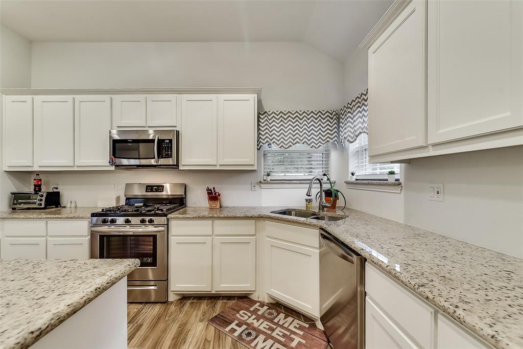 A kitchen with stainless steel appliances and granite counter tops