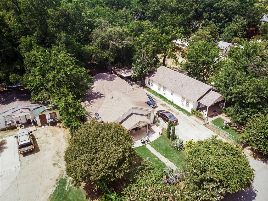 An aerial view of a house surrounded by trees
