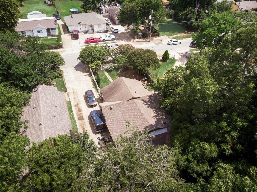 An aerial view of a residential area with houses and trees