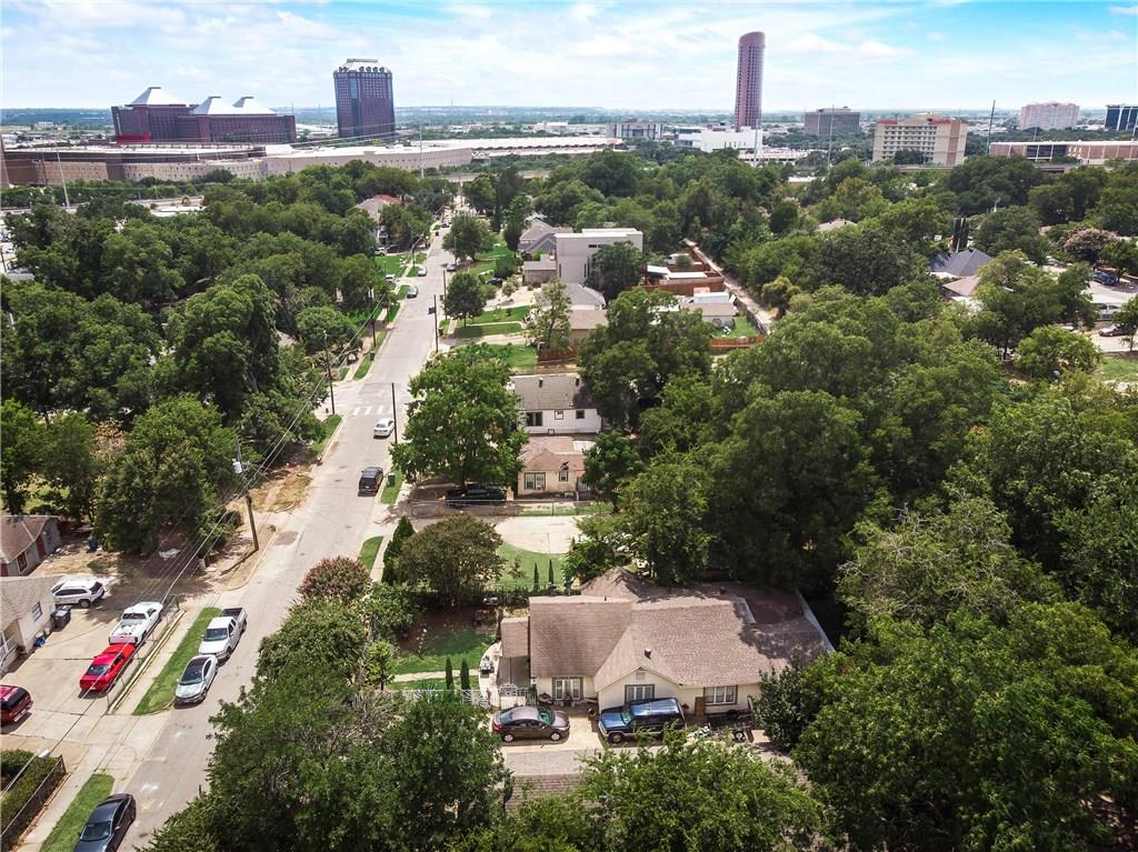 An aerial view of a residential area with a city in the background
