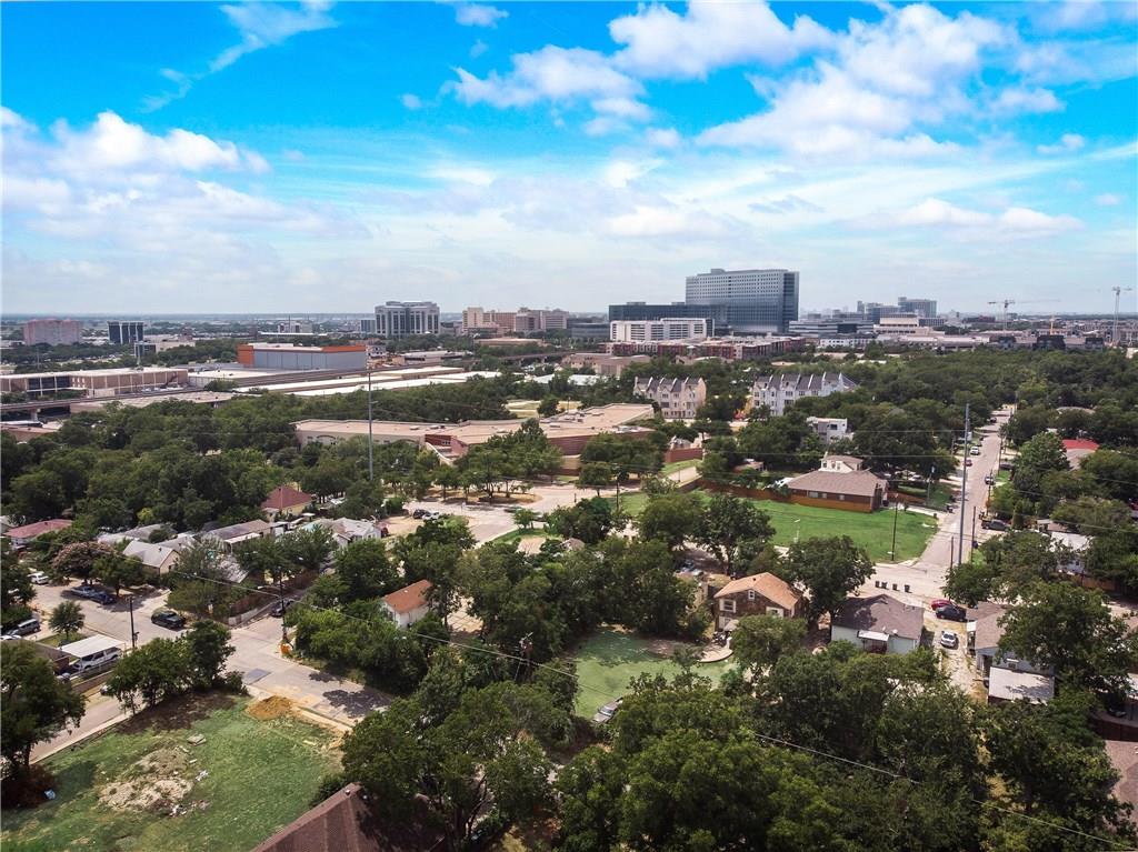 An aerial view of a city with a lot of trees and buildings.