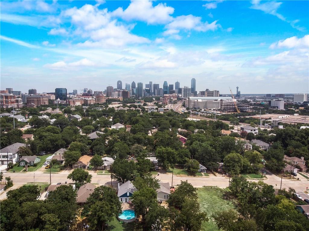 An aerial view of a residential area with a city skyline in the background.