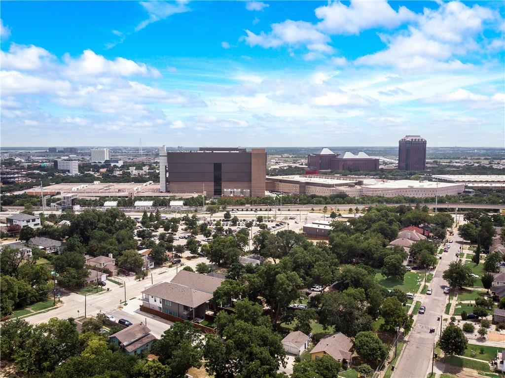 An aerial view of a residential area with a city in the background.