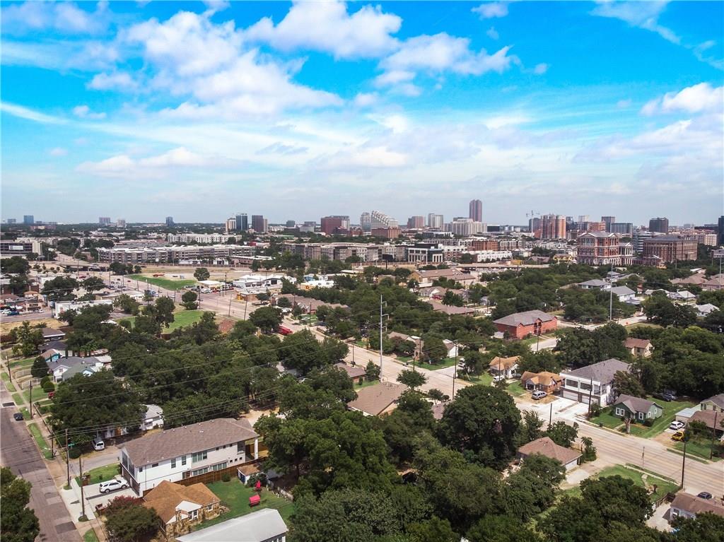 An aerial view of a residential area with a city in the background.