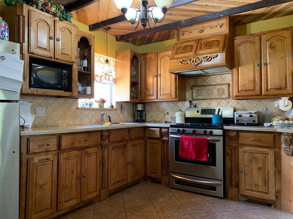 A kitchen with wooden cabinets and stainless steel appliances