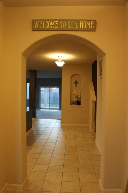 A hallway with a sign that says welcome to our home