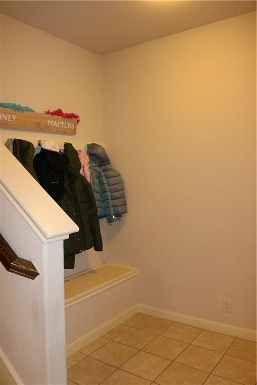 A hallway with jackets hanging on a shelf that says 
