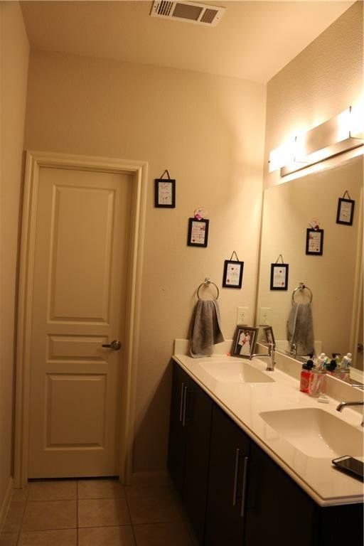 A bathroom with two sinks and a large mirror