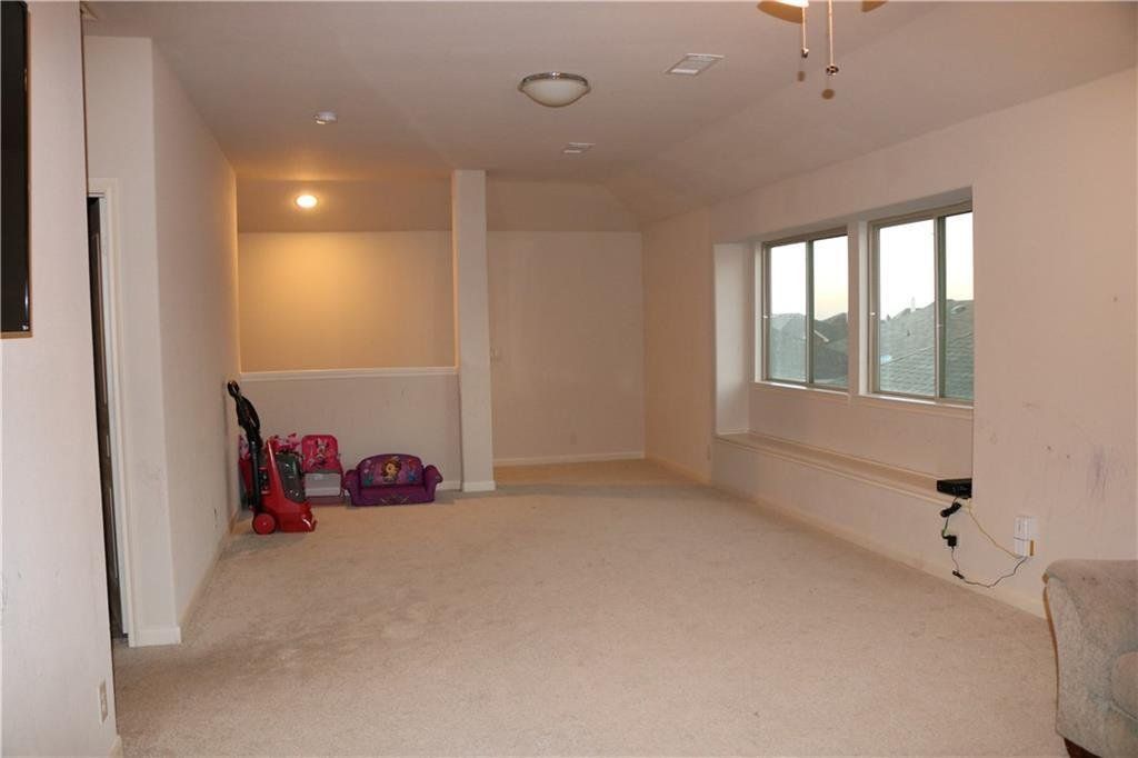 A large empty room with a lot of windows