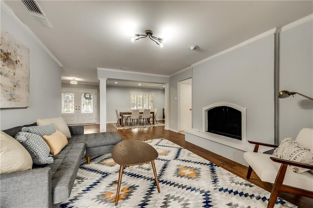 A living room with a couch , chairs , coffee table and fireplace.