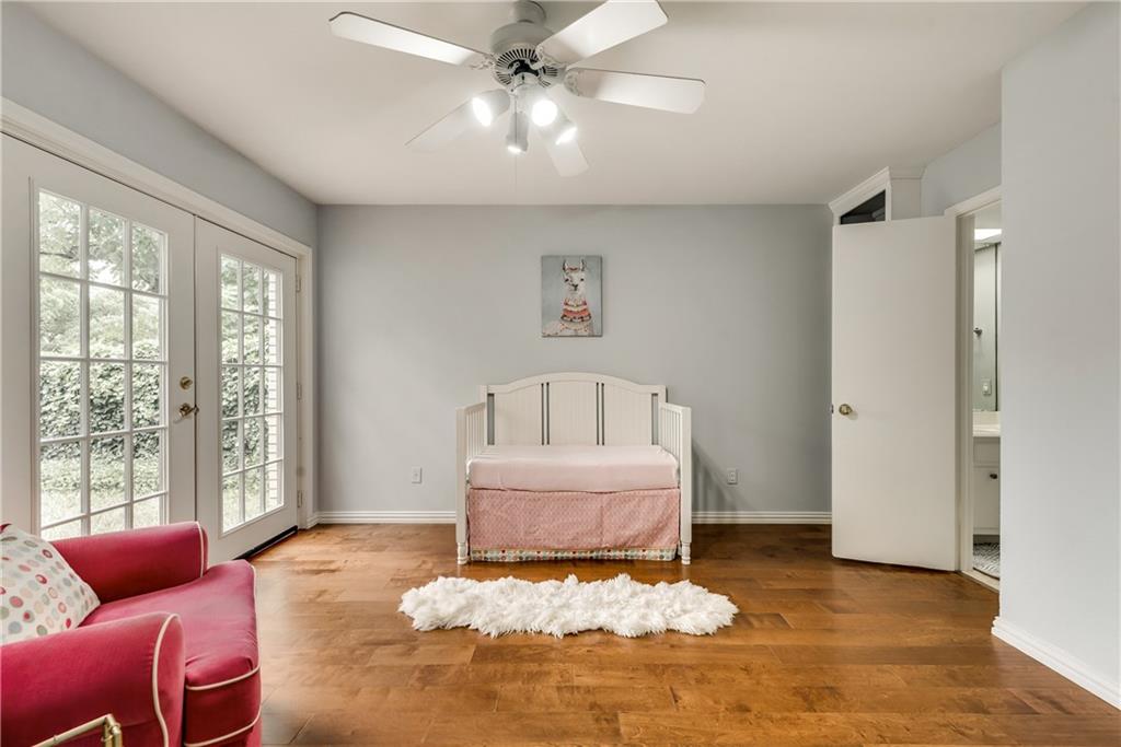A bedroom with a bed and a ceiling fan
