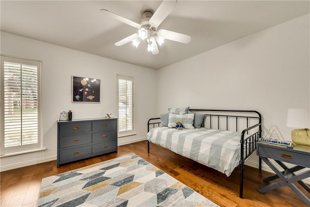 A bedroom with a day bed and a ceiling fan.